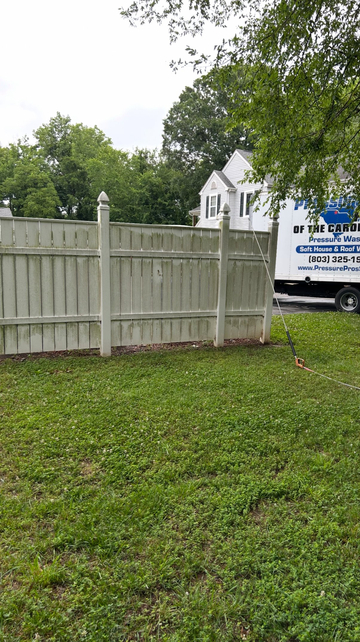 Before — vinyl fence with discoloration